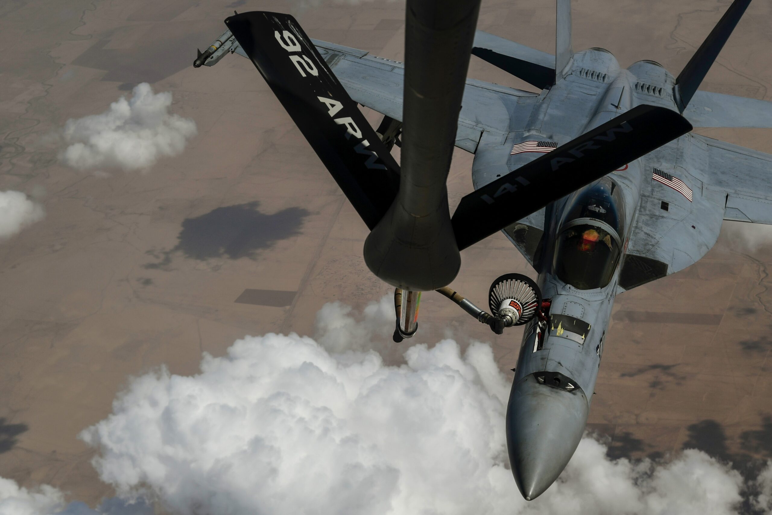 KC-135 Stratotanker refuels a Navy F/A-18E Super Hornet