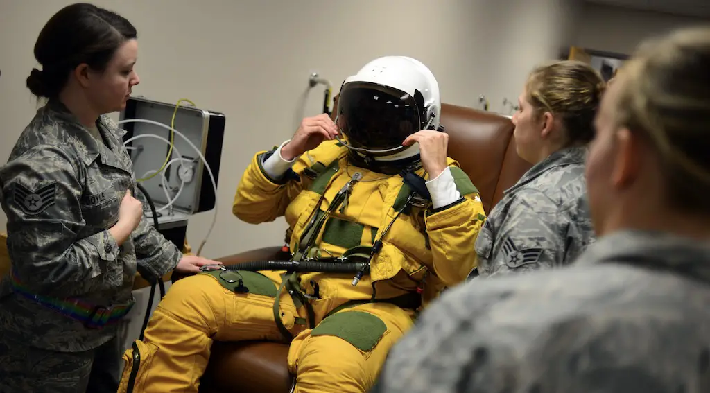 U-2 pilot Capt. Travis dawns the sun visor on his pressure suit helmet during pre-flight suit dawning in preparation