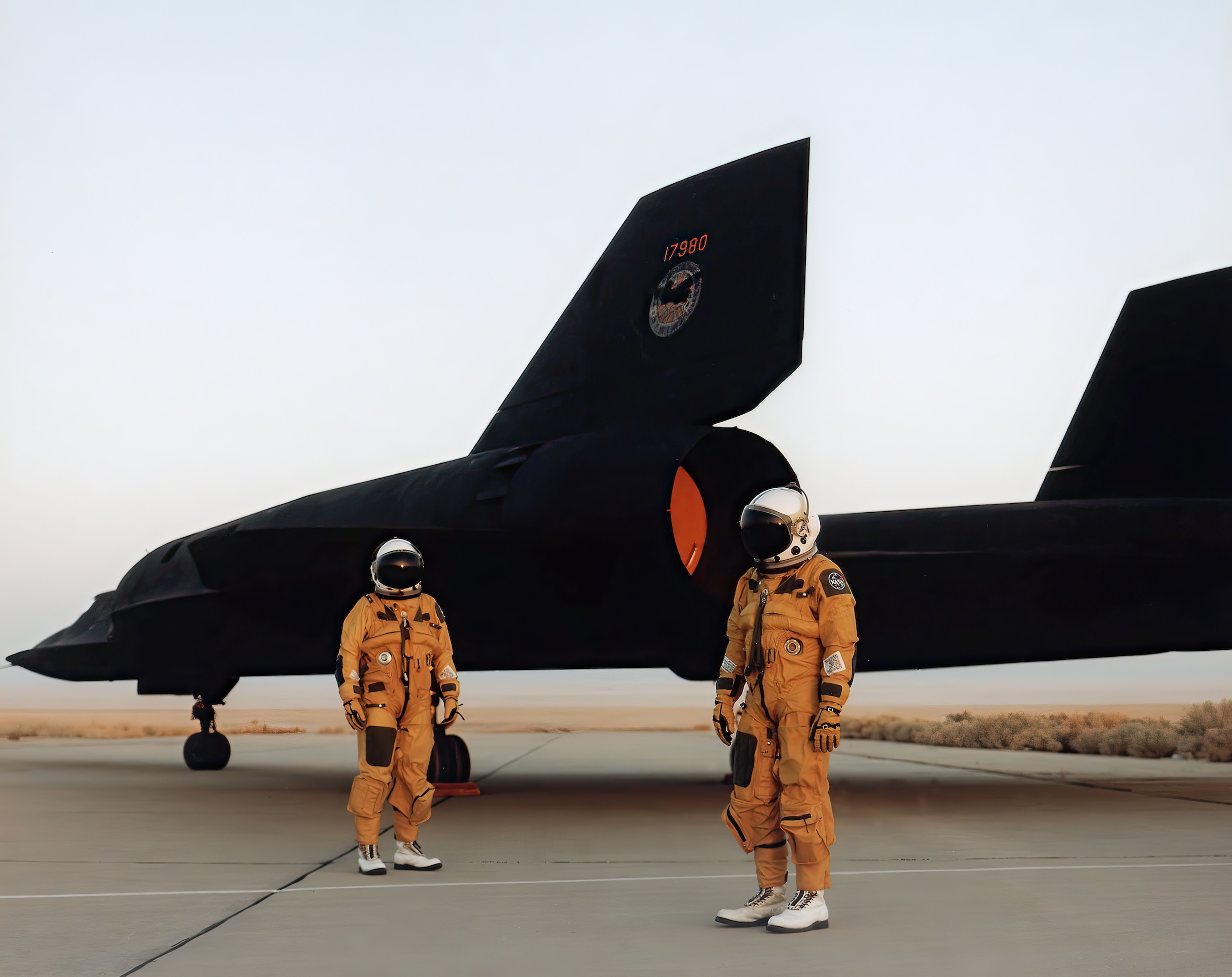 The crew of a NASA Lockheed SR-71 Blackbird standing by the aircraft in their pressurized flight suits