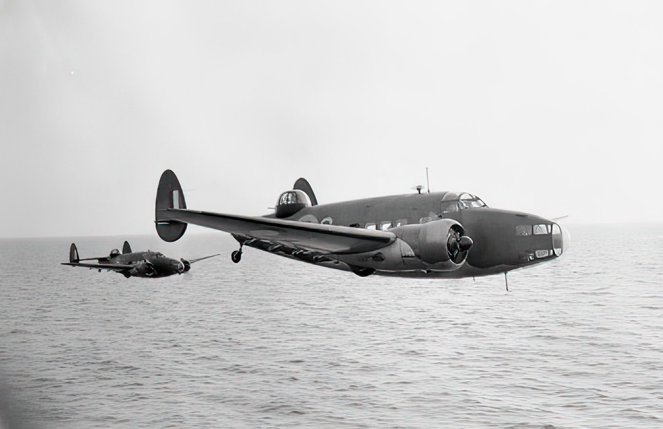 A pair of Lockheed Hudsons fly over the Sea