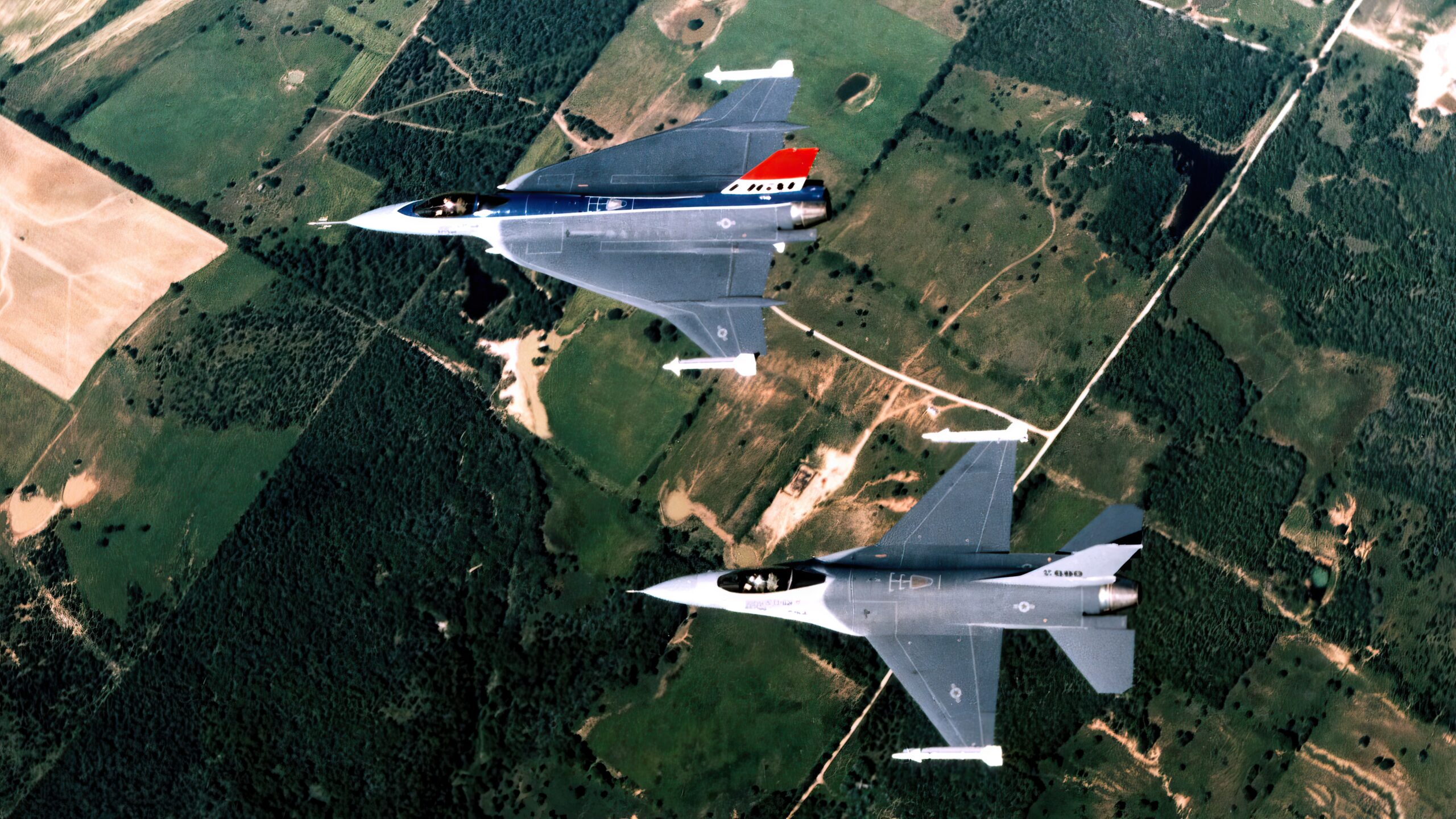 An air-to-air top left view of an F-16XL prototype and the F-16 Fighting Falcon aircraft