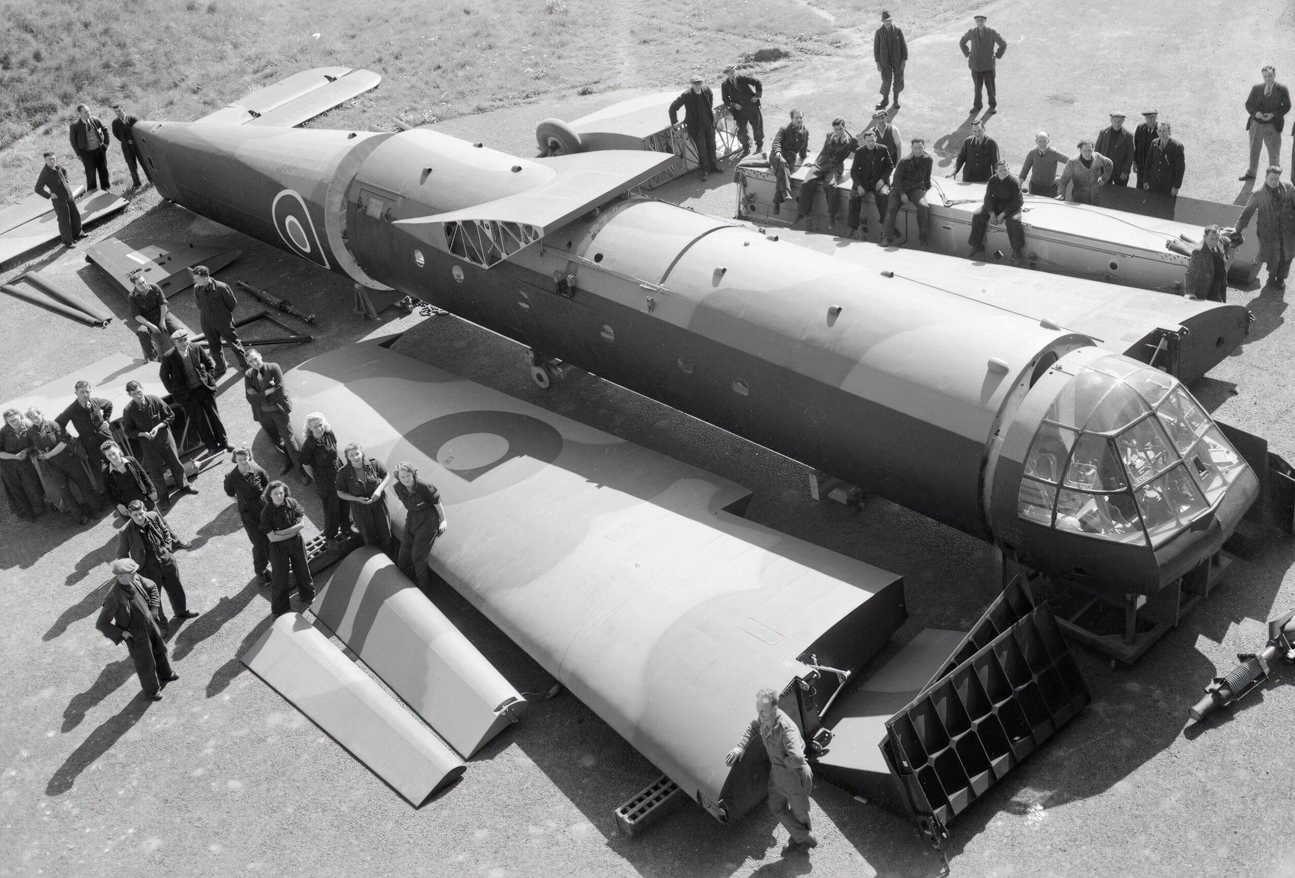 Civilian workers pose with sections of an Airspeed Horsa glider, as received from the manufacturers, before assembling it at No. 6 Maintenance Unit, Brize Norton, Oxfordshire April 26 1944