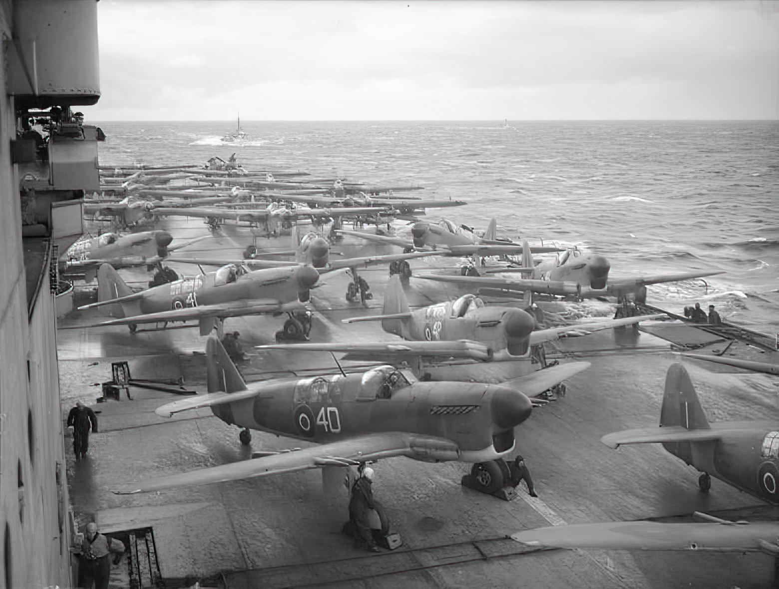 Fairey Fireflies (1771 Squadron), Fairey Barracudas (828 Squadron), and Supermarine Seafires (880 Squadron) of the Fleet Air Arm on the flight deck of HMS Implacable (R86) warming up ready to make strike on enemy shipping at the entrance to Alten Fjord, Norway 1944