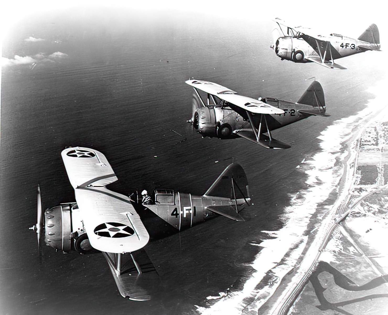 Three Grumman F3F-1 fighters of U.S. Navy fighter squadron VF-4 from the aircraft carrier USS Ranger (CV-4) over Southern California, January 1939