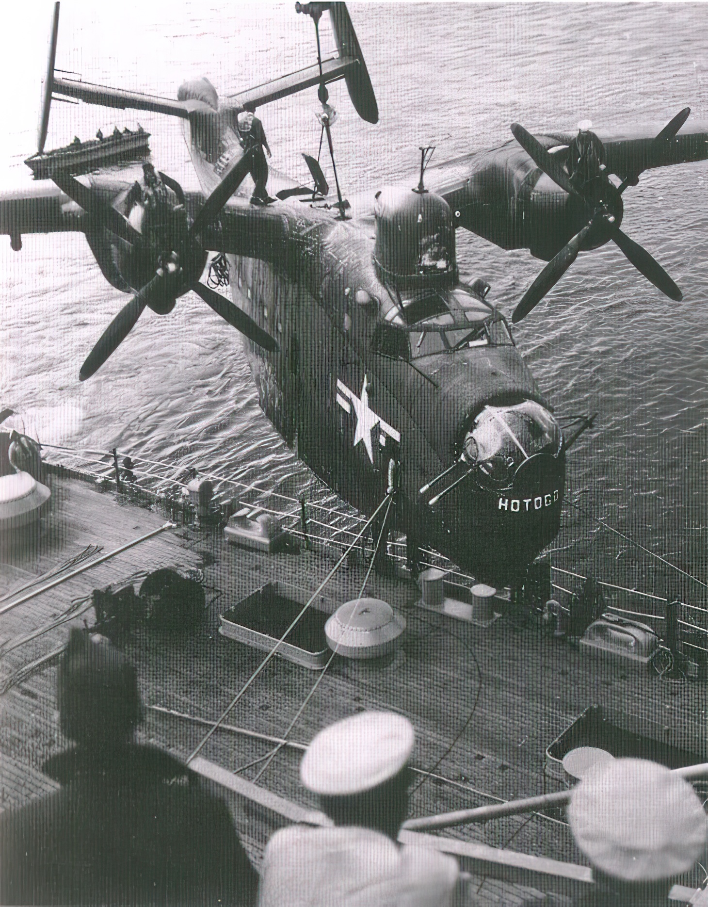 A United States Navy PBM Mariner flying boat of Fleet Air Wing 6 is hoisted aboard the U.S. Navy seaplane tender USS Curtiss (AV-4) after returning from a mine-hunting patrol off North Korea during the Korean War