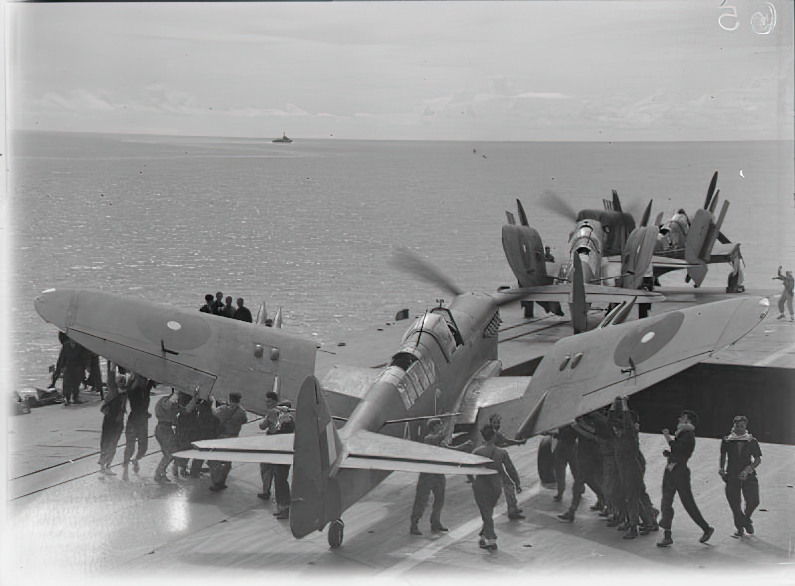 Men folding the wings of a Fairey Firefly of 1770 Squadron, Fleet Air Arm on board HMS INDEFATIGABLE on the aircraft's return from the carrier-borne air strike on the Japanese oil refinery at Pangkalan Brandan, Sumatra. Weather conditions were excellent and the whole weight of bombs and missiles from the Grumman Avengers and Fairey Fireflies fell within the target area. The powerhouse and other important plants, together with oil tanks and buildings, received direct hitsen folding the wings of a Fairey Firefly of 1770 Squadron, Fleet Air Arm on board HMS INDEFATIGABLE on the aircraft's return from the carrier-borne air strike on the Japanese oil refinery at Pangkalan Brandan, Sumatra. Weather conditions were excellent and the whole weight of bombs and missiles from the Grumman Avengers and Fairey Fireflies fell within the target area. The powerhouse and other important plants, together with oil tanks and buildings, received direct hits