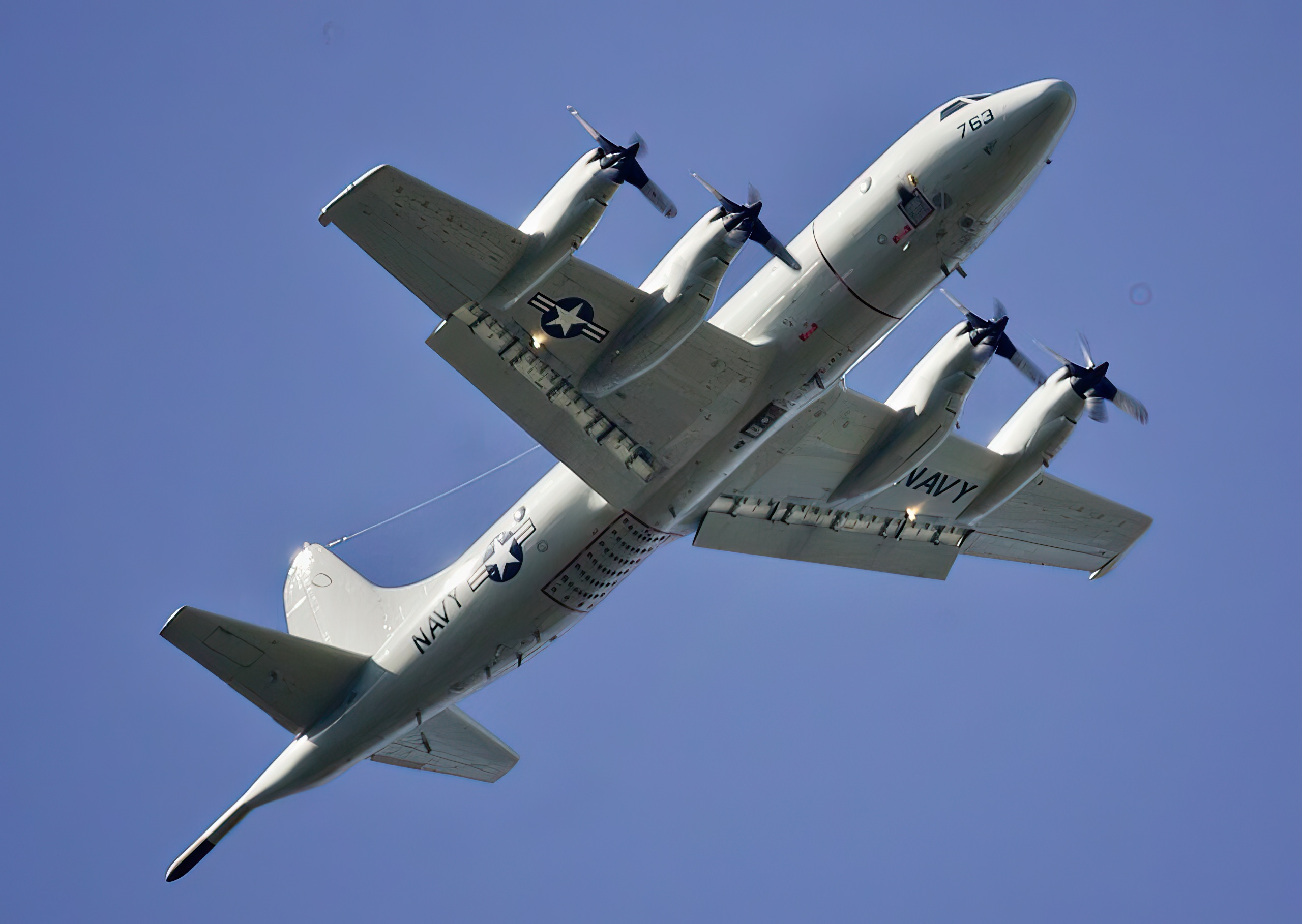 An underside view of a P-3C "Orion" submarine-hunter airplane in flight