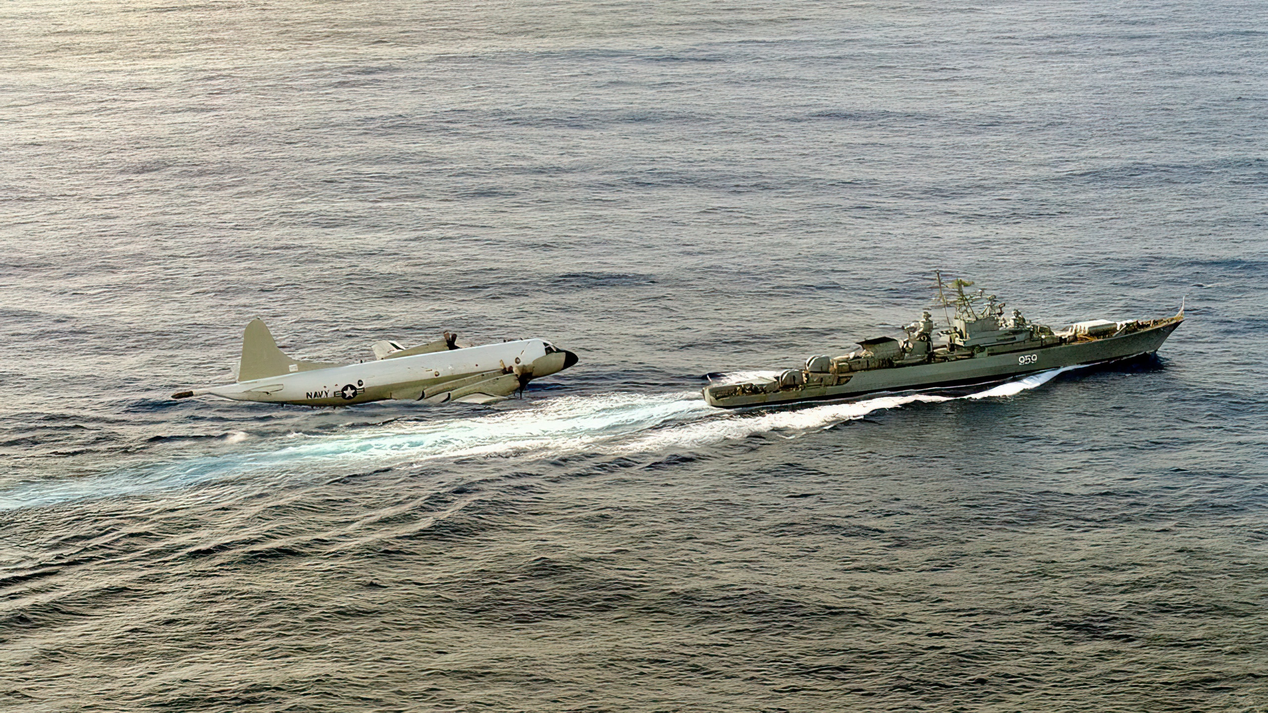 The Soviet Bditel'nyy class (NATO code Krivak I) guided missile frigate Zadornyy underway as a U.S. Navy P-3 Orion aircraft conducts fly-by surveillance.