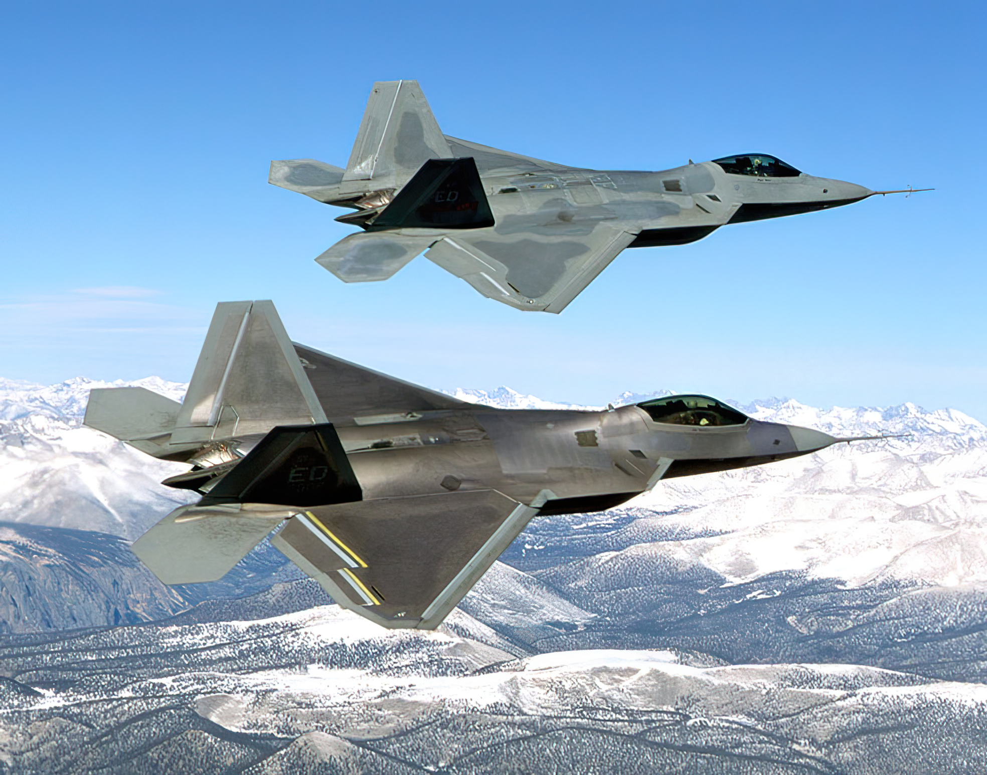 Two F-22s during flight testing, the upper one being the first EMD F-22, Raptor 4001