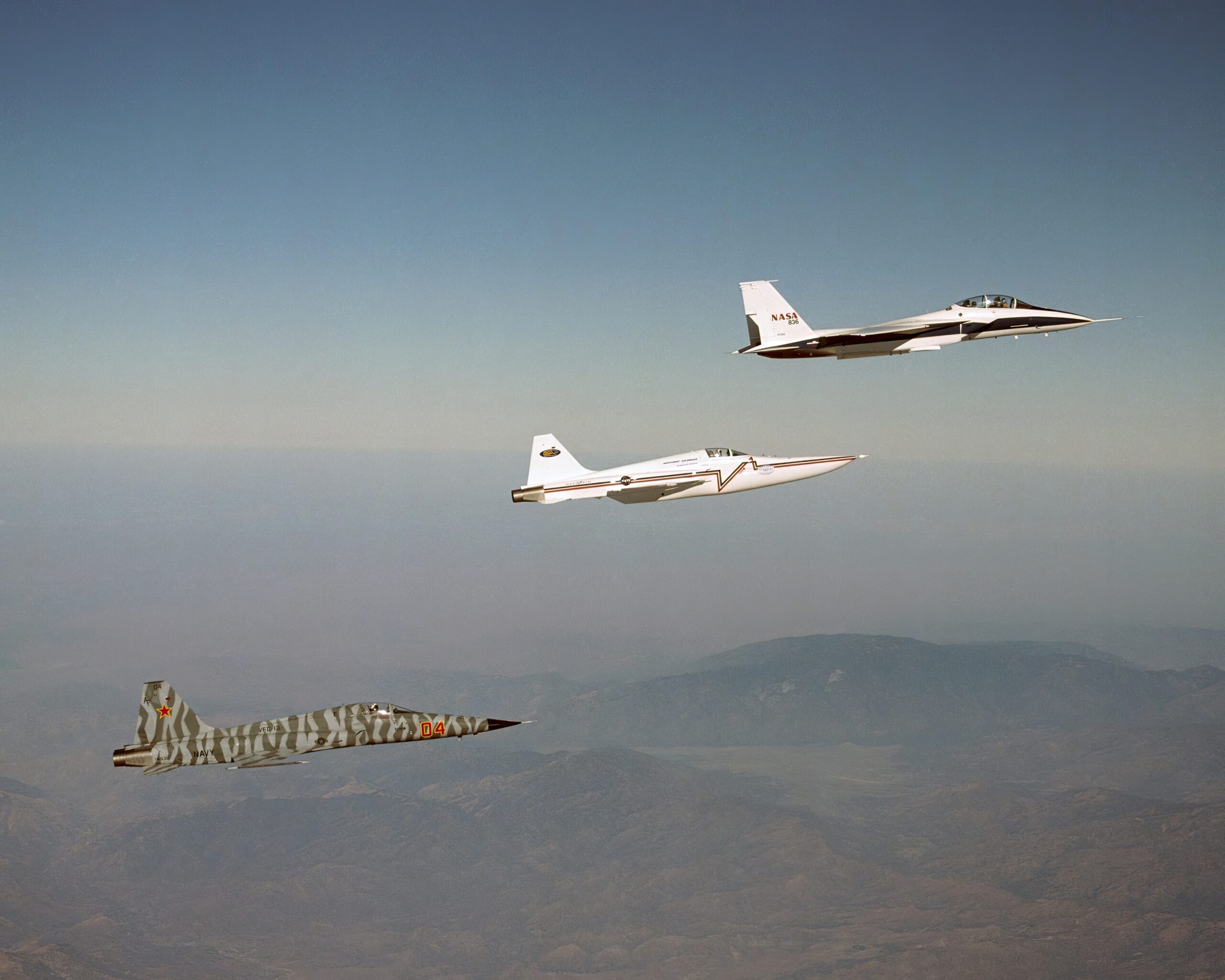 Northrop Grumman Corp.'s modified F-5E Shaped Sonic Boom Demonstration SSBD aircraft flies off the wing of NASA's F-15B Research testbed aircraft. The F-15B, from NASA's Dryden Flight Research Center