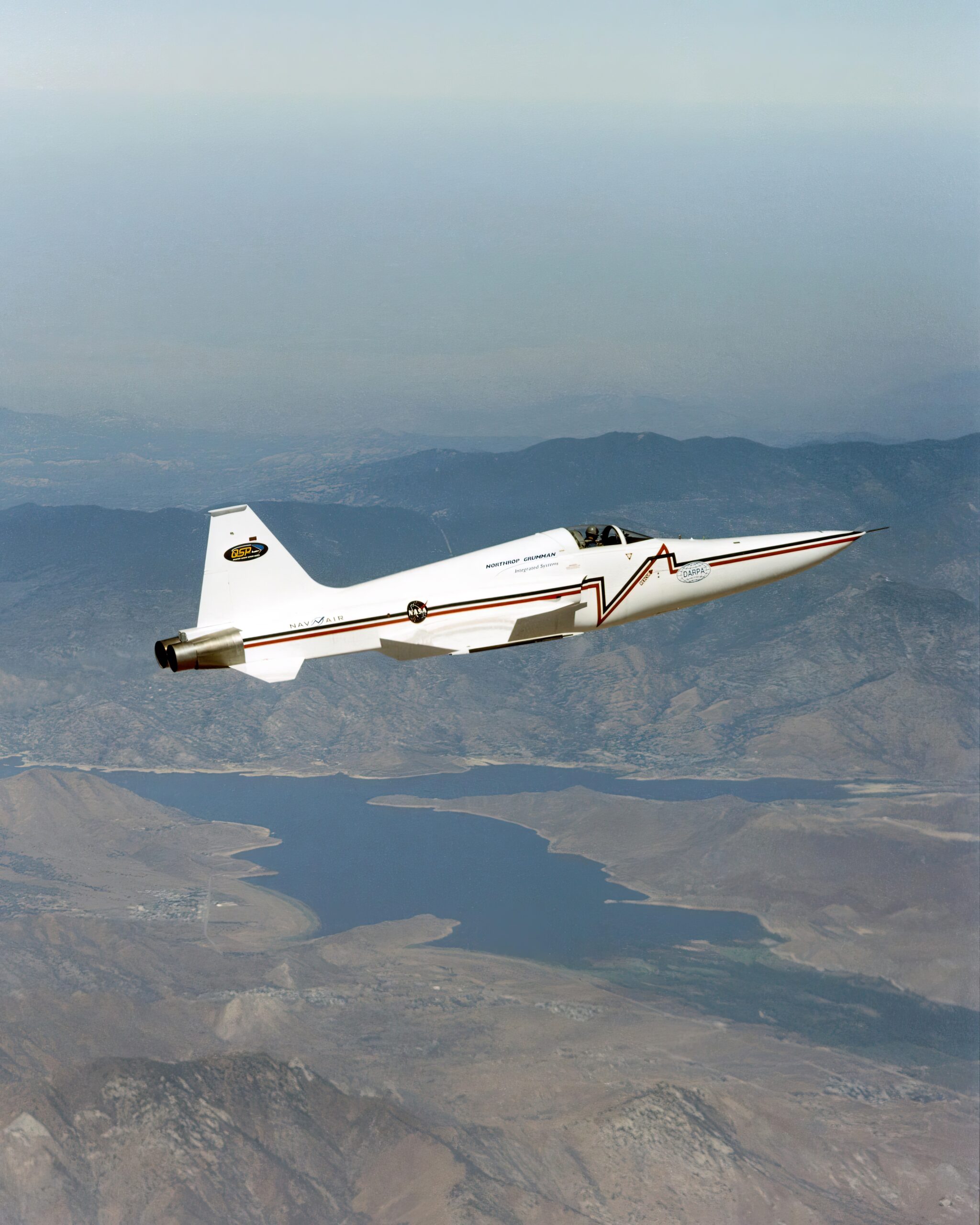 Northrop Grumman Corporation's modified U.S. Navy F-5E Shaped Sonic Boom Demonstration SSBD aircraft flies over Lake Isabella, California