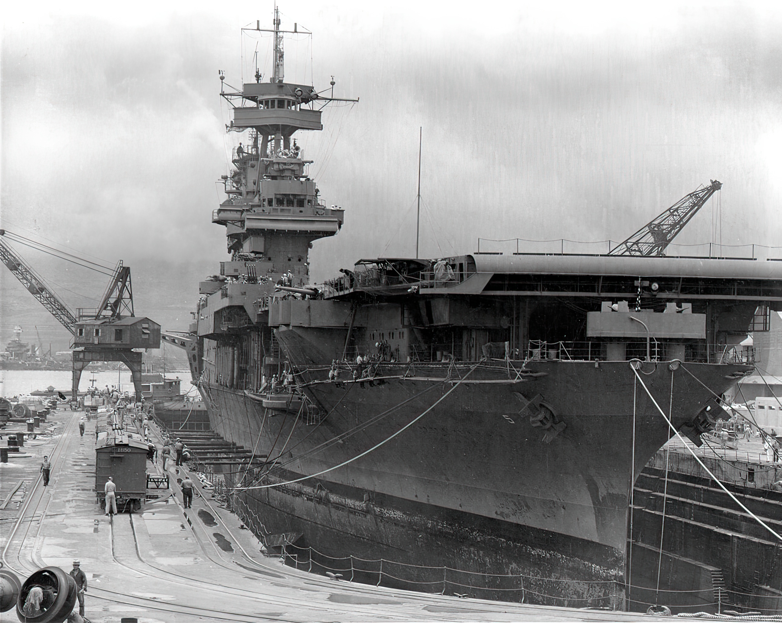 The U.S. Navy aircraft carrier USS Yorktown (CV-5) in Dry Dock No. 1 at the Pearl Harbor Naval Shipyard, 29 May 1942, receiving urgent repairs for damage received in the Battle of Coral Sea. She left Pearl Harbor the next day to participate in the Battle of Midway