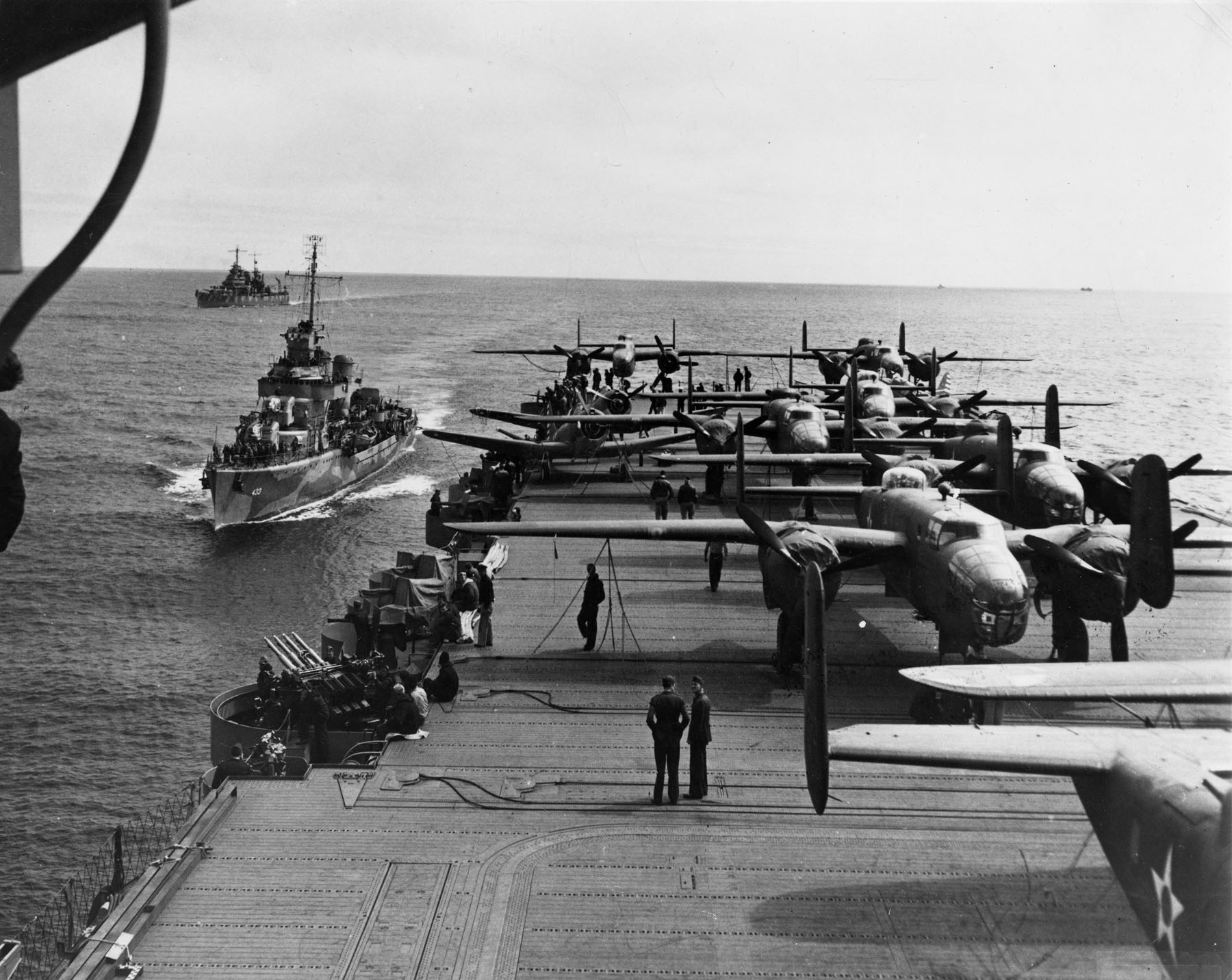 A pair of alert escorts follow the USS Hornet with carried 16 B-25 bombers for the ‘Doolittle Raid’ on April 18, 1942. US Air Force Photo