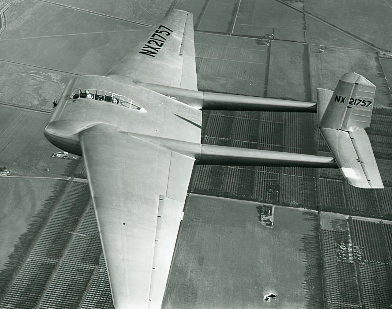 High right side aerial view of General Airborne XCG-16 glider (r/n NX21757) in flight, caption on photo reverse, 'Oxnard, California XCG-16, 1944, Pilot Major R.R. Shoop, Co-Pilot Mr. Howard Morrison'.