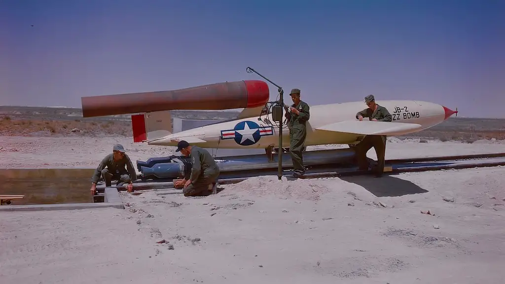 Technicians at the U.S. Air Force guided missile test base at Holloman Air Force Base, Alamogordo, New Mexico, rig the rocket launcher to a JB-2 buzz bomb just before a test flight of the pulse-jet subsonic missile. A copy of the Nazi V-1 which rained down on London during the war, this missile still yields important data in tests conducted by Air Force research engineers