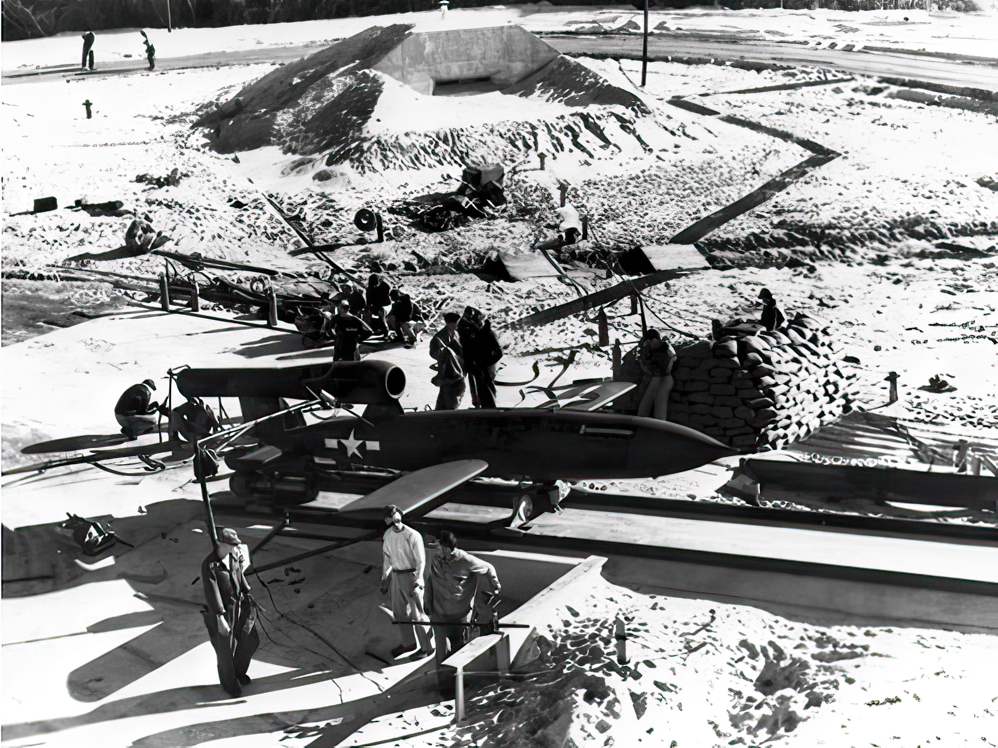 JB-2 setup on concrete rail ramp for flight over Gulf of Mexico from Santa Rosa Island, note bunker in rear of photo