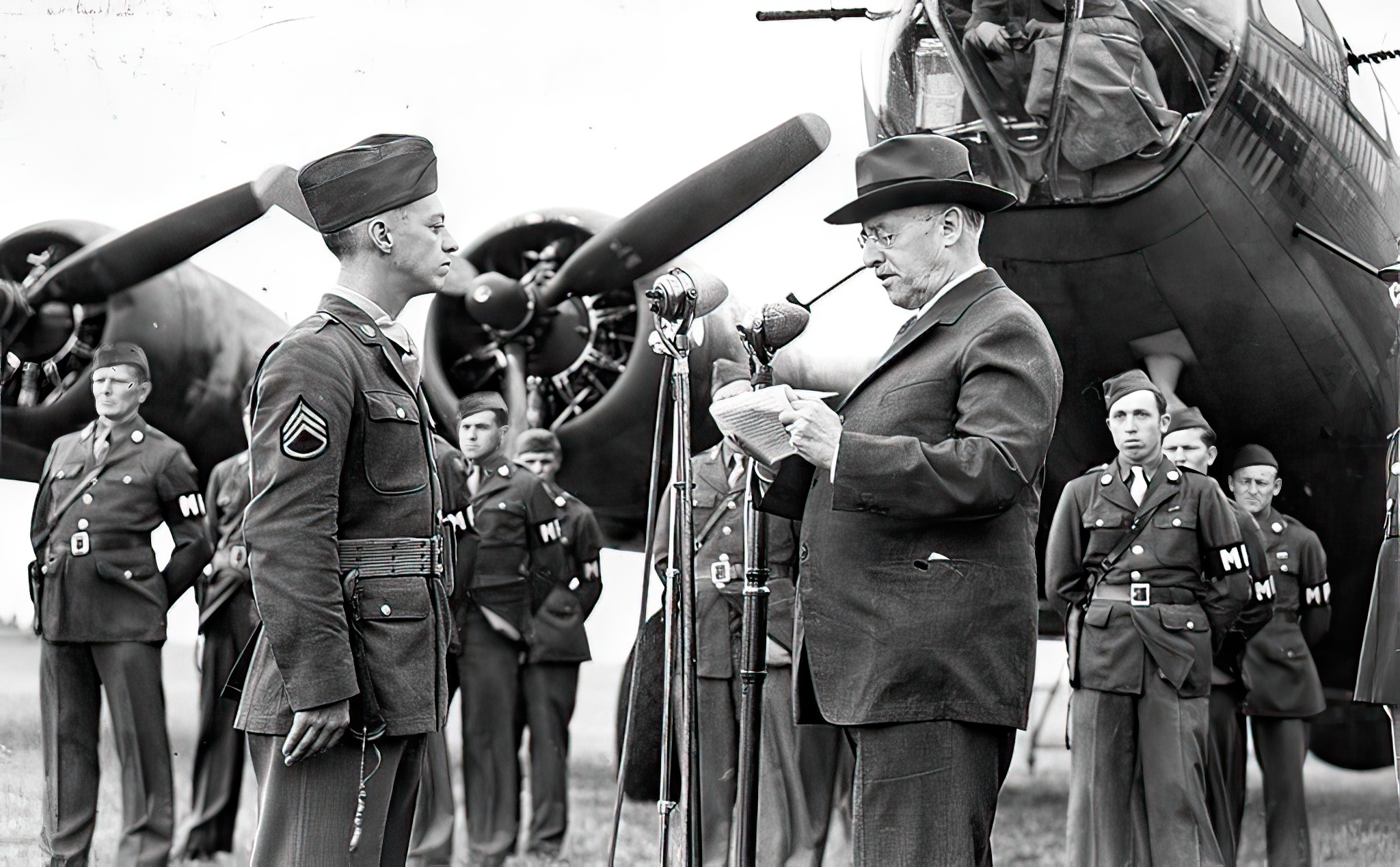 Staff Sergeant Maynard Smith of the 306th Bombardment Group, is presented with the Medal of Honor by Secretary of War Henry L Stimson in front of a B-17 Flying Fortress at Thurleigh Airfield, USAAF Station 111, England