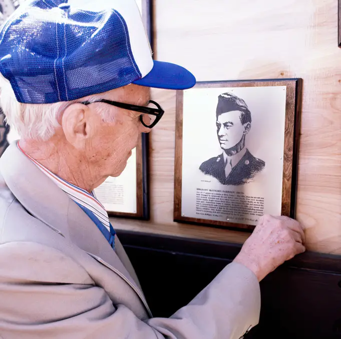 Maynard Harrison Smith inspects plaque commemorating his award