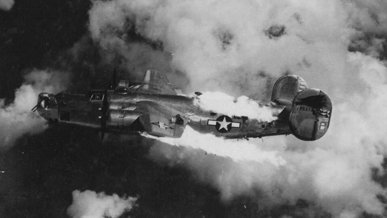 A B-24 Liberator (serial number 42-95379) nicknamed "Extra Joker" of the 451st Bomb Group, 15th Air Force on fire over Austria following an attack by German fighters. Image taken by Leo S Stoutsenberger, Photographic Officer, 451st Bomb Group