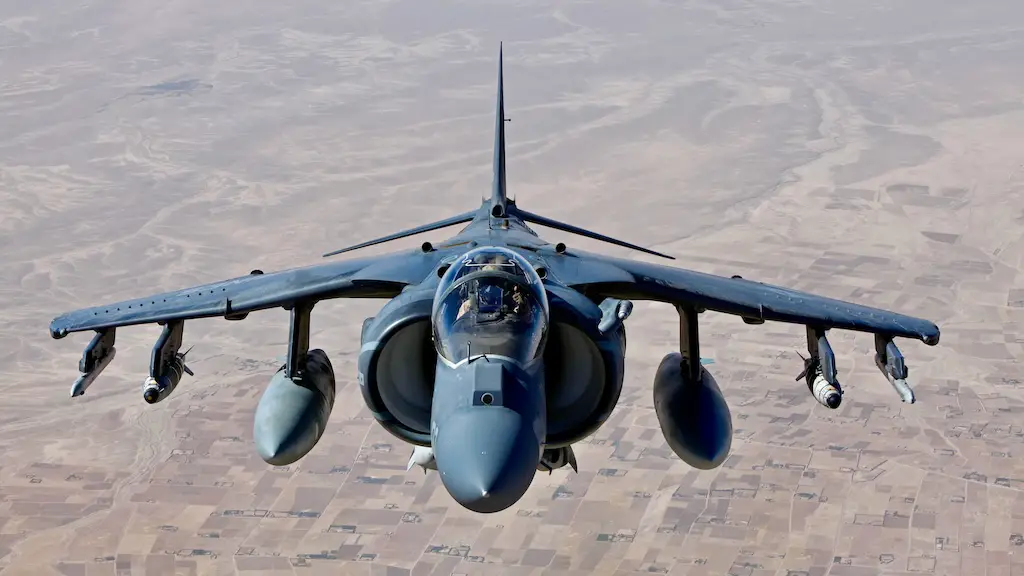 A AV-8B Harrier jet with Marine Attack Squadron 311, flies over Helmand province, Afghanistan June 10, 2013. The jet had just received aerial refueling support from a KC-130J Hercules aircraft with Marine Aerial Refueler Transport Squadron 252, before continuing their air operations. (U.S. Marine Corps photo by Sgt. Gabriela Garcia/Released)