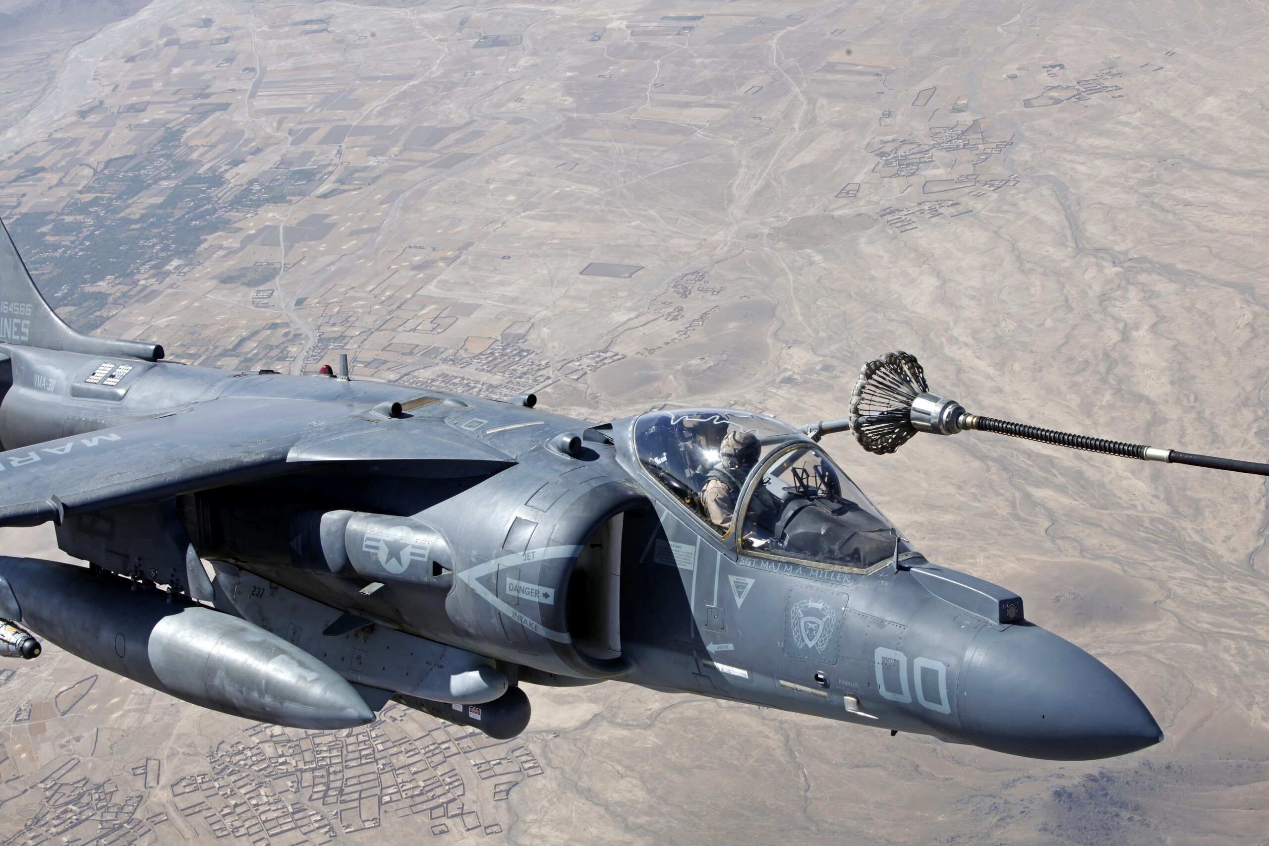 AV-8B Harrier jets with Marine Attack Squadron 311 receive support from a KC-130J Hercules aircraft with Marine Aerial Refueler Transport Squadron 252 over Helmand province, Afghanistan