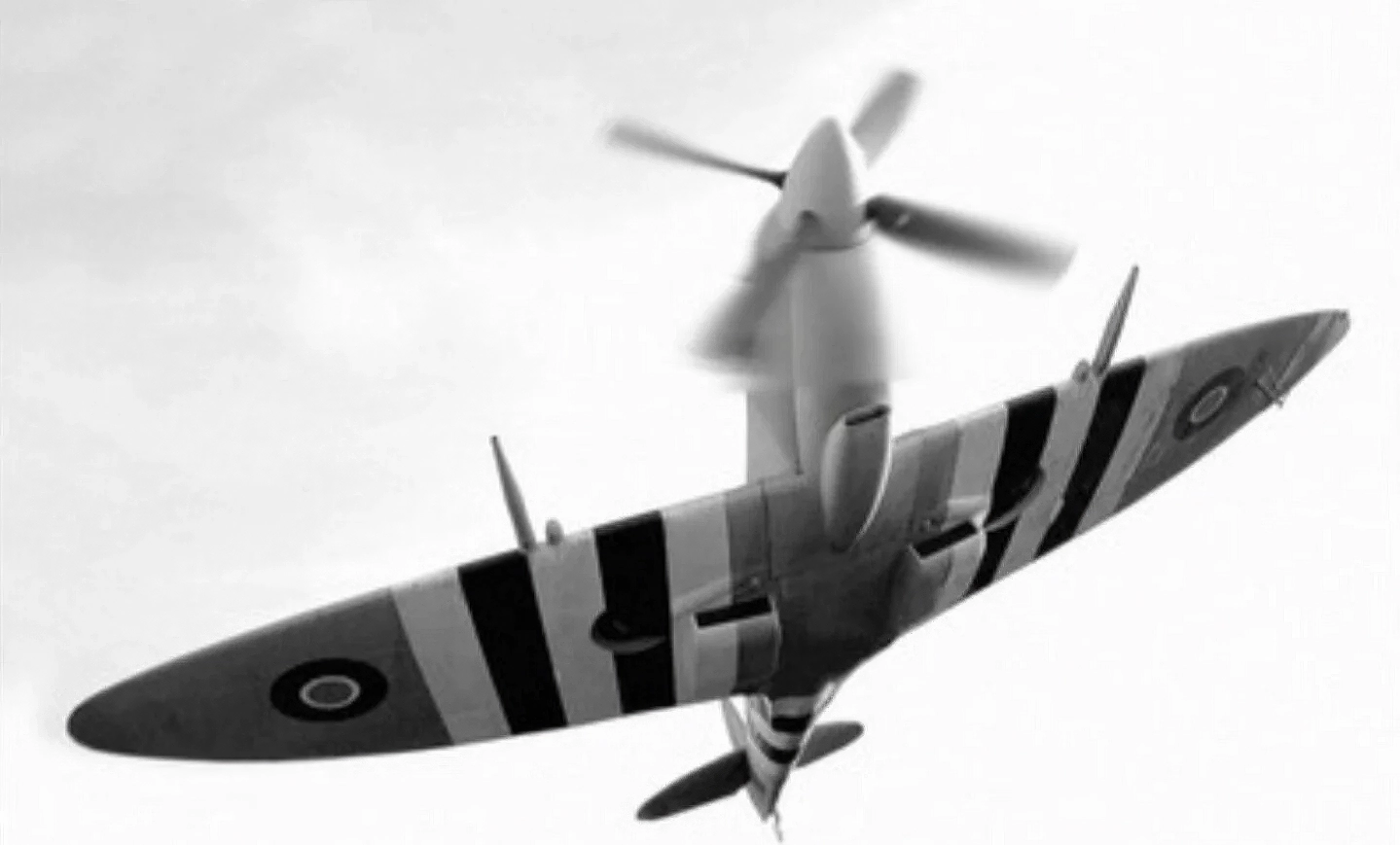 Spitfire Mk IX with invasion stripes in flight